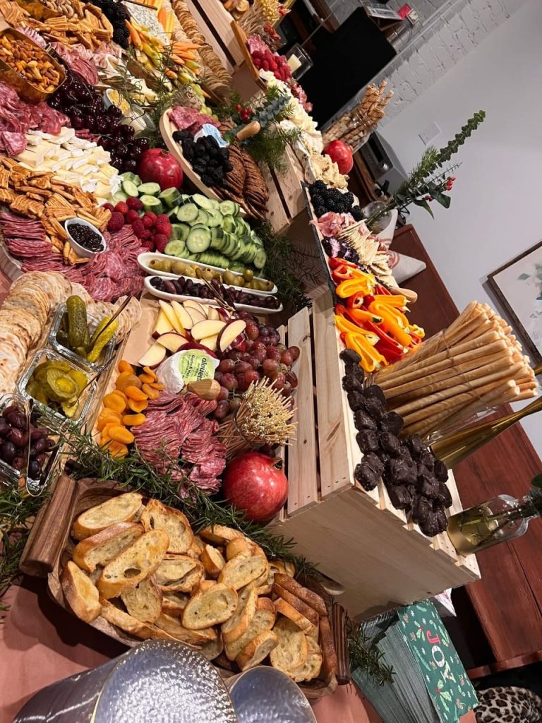 Large gourmet charcuterie board with cheeses, meats and fruit