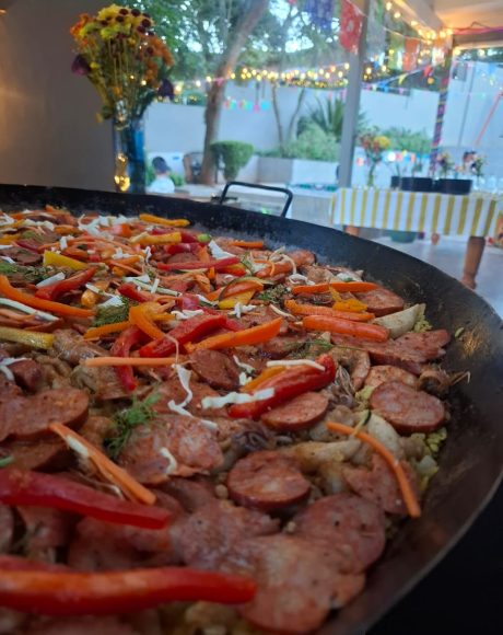 Traditional chicken and chorizo paella served at an evening event