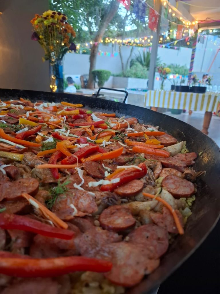 Traditional chicken and chorizo paella served at an evening event