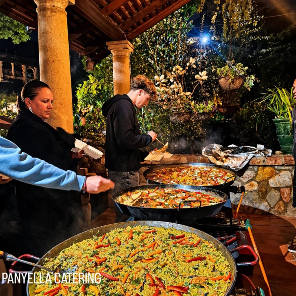 Guests enjoying live paella catering at an evening event in Gauteng