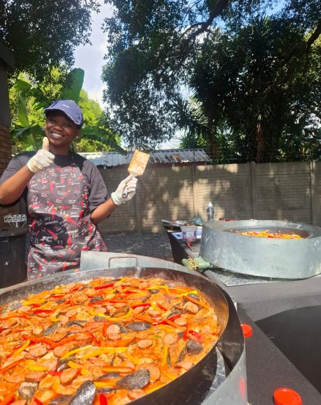 Chef preparing fresh seafood paella at an outdoor catered event in Johannesburg
